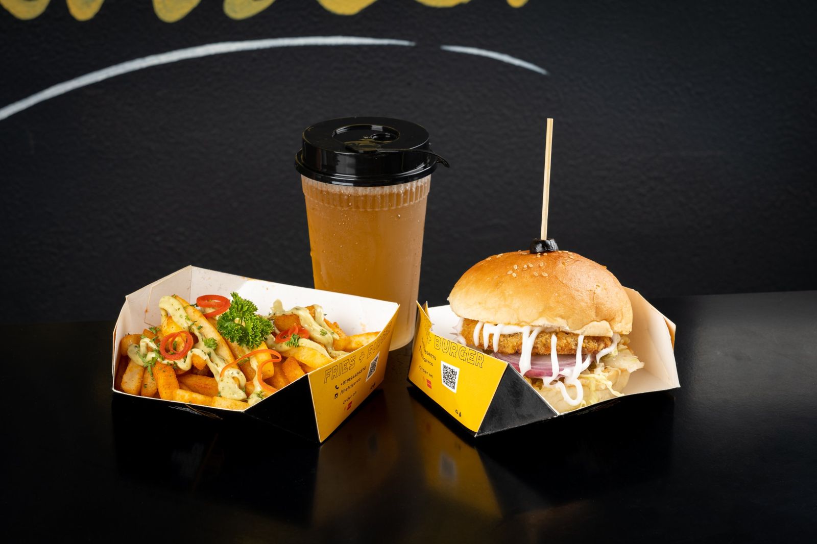 Friger burger, loaded fries and iced tea in yellow Friger boxes