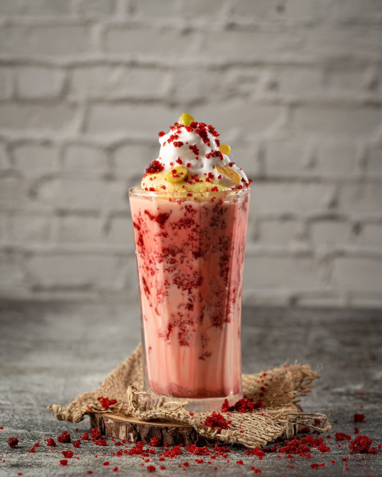 A thick shake topped with cream and crumbs